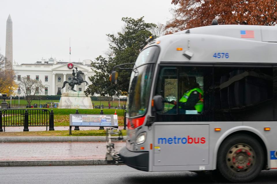 A Metrobus moves past the White House in Washington, Wednesday, Dec. 7, 2022. The Washington DC government voted to waive fares for Metrobus rides within city limits starting July, 1, 2023, becoming the nation's most populous city to offer free public transit.