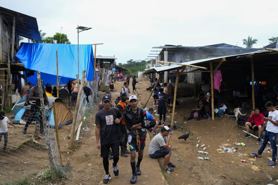 Migrants gather after trekking through the Darien Gap, in Bajo Chiquito, Panama, Wednesday, Oct. 4, 2023. (AP Photo/Arnulfo Franco)