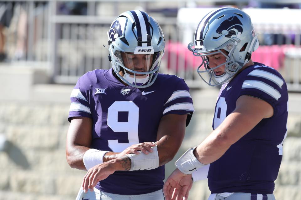 Kansas State quarterbacks Adrian Martinez (9) and Will Howard (18) compare notes during warmups before Saturday night's game against South Dakota  Bill Snyder Family Stadium.