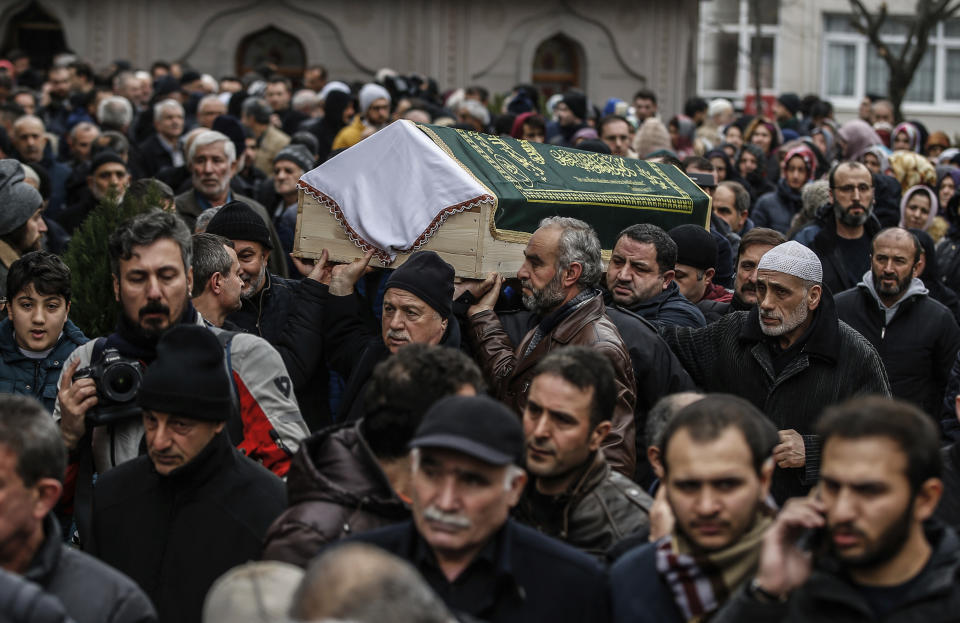 People carry the coffin of Fatma Kahraman, 63, a victim who lost her life under the rubble of an eight-story building which collapsed two days earlier in Istanbul, Friday, Feb. 8, 2019. The cause of the collapse is under investigation but a top Turkish official has said the building's top three floors were added illegally. (AP Photo/Emrah Gurel)