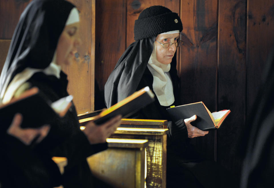 In this Thursday, Dec. 22, 2011 photo, Mother Dolores Hart, right, participates in two of seven daily prayers in the Abbey of Regina Laudis monastery in Bethlehem, Conn. Mother Dolores, a cloistered nun whose luminous blue eyes entranced Elvis Presley in his first on-screen movie kiss, is praying for a Christmas miracle. She walked away from Hollywood stardom in 1963 to become a nun in rural Bethlehem. Now she finds herself back in the spotlight, but this time it's all about serving the King of Kings, not smooching the King of Rock and Roll. The former brass factory that houses Mother Dolores and about 40 other nuns cloistered at the Abbey of Regina Laudis needs millions of dollars in renovations to meet fire and safety codes, add an elevator and make handicap accessibility upgrades. (AP Photo/Jessica Hill)