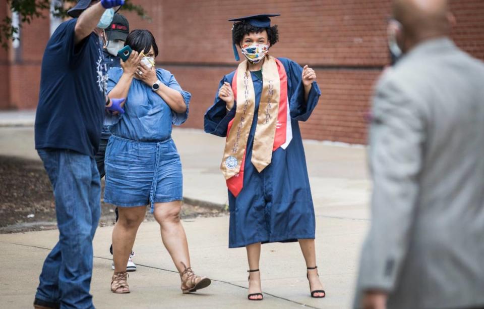 Jordan Chambers dances while posing for a picture with her family at Southeast Raleigh High School’s socially distanced graduation ceremony on Wednesday, May 27, 2020.