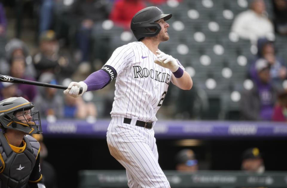Colorado Rockies' Ryan McMahon follows the flight of his RBI-double off Pittsburgh Pirates relief pitcher Dauri Moreta in the ninth inning of a baseball game Wednesday, April 19, 2023, in Denver. (AP Photo/David Zalubowski)