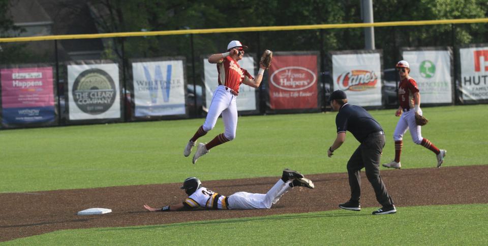 Watkins Memorial's Cole Massie slides safely beneath Bishop Watterson's Ryan Rudzinski to steal second base on Tuesday.