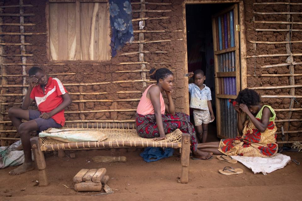 A family rests outside their new home at the Corrane IDP site (Hélène Caux/UNHCR)