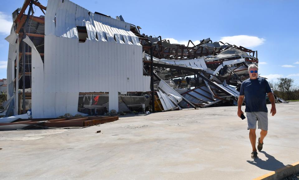 Wayne Stoutner of Rotonda, Florida, walks away from the damaged dry boat storage at Palm Harbor Marina in Placida, after checking on the status of his boat on Thursday, Sept. 29, 2022.  Stoutner said he located his boat in the structure and it appeared to be undamaged, but predicted it was going to be a while before they could get it out. 