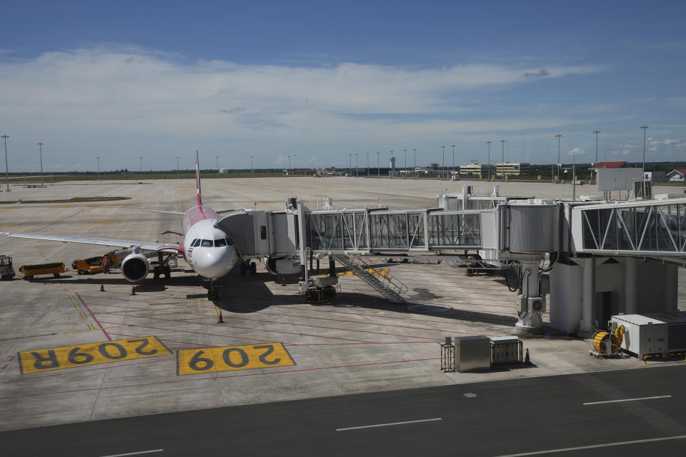 A plane stands parked in the Siem Reap-Angkor International Airport, in Cambodia as it opened Thursday, Nov. 16, 2023. Cambodia on Thursday officially inaugurated the country's newest and biggest airport, a Chinese-financed project meant to serve as an upgraded gateway to the country’s major tourist attraction, the centuries-old Angkor Wat temple complex in the northwestern province of Siem Reap. (AP Photo/Heng Sinith)