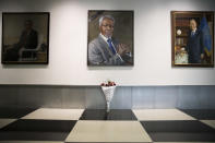 A black ribbon and a bouquet of flowers adorn the portrait of former United Nations Secretary-General Kofi Annan at U.N. headquarters, Saturday, Aug. 18, 2018. Annan, one of the world's most celebrated diplomats and a charismatic symbol of the United Nations who rose through its ranks to become the first black African secretary-general, has died. He was 80. (AP Photo/Mary Altaffer)