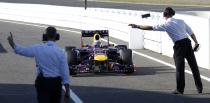 Red Bull Formula One driver Sebastian Vettel of Germany is directed to the Parc Ferme after the qualifying session of the Japanese F1 Grand Prix at the Suzuka circuit October 12, 2013. REUTERS/Issei Kato (JAPAN - Tags: SPORT MOTORSPORT F1)