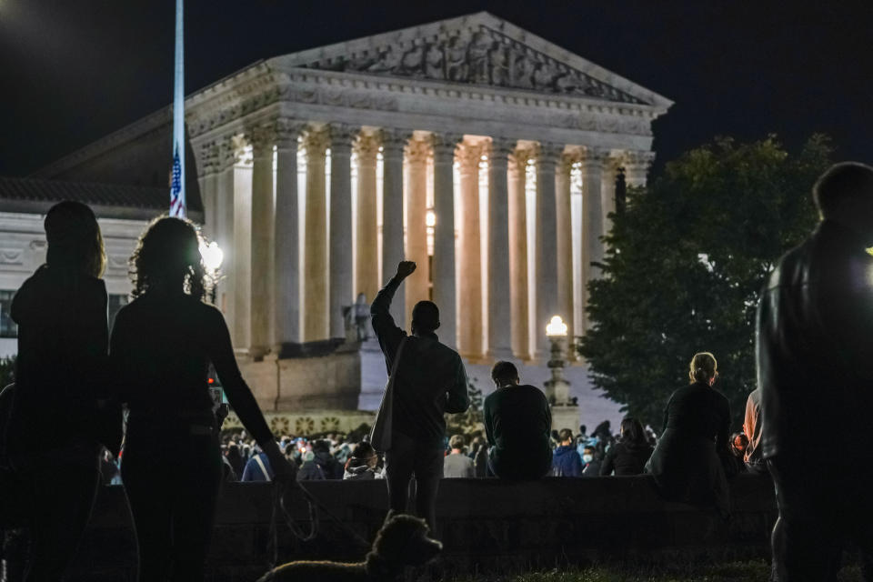 FILE - In this late Saturday, Sept. 19, 2020, file photo, people gather at the Supreme Court in Washington, to honor the late Justice Ruth Bader Ginsburg, one of the high court's liberal justices, and a champion of gender equality. Her death leaves a vacancy that could be filled with a more conservative justice by President Donald Trump. (AP Photo/J. Scott Applewhite, File)