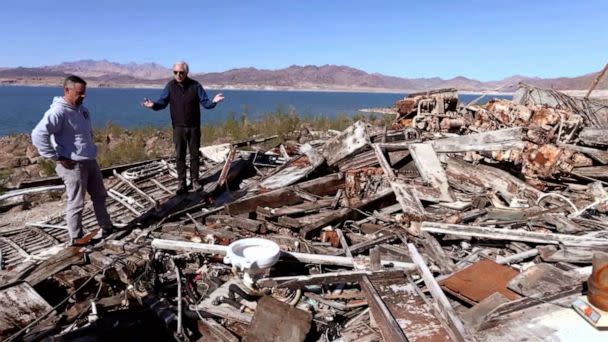 PHOTO: ABC News' Chris Connelly surveys a previously submerged boat wreck on Lake Mead. (ABC News)