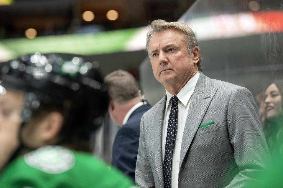 FILE - Dallas Stars then-interim head coach Rick Bowness watches play from behind the bench during the third period of an NHL hockey game against the New Jersey Devils in Dallas, in this Tuesday, Dec. 10, 2019, file photo. The Stars have most of their same group back this season and head coach Rick Bowness has shed the interim tag he had. (AP Photo/Jeffrey McWhorter, File)