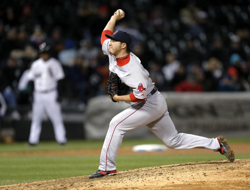 Boston Red Sox relief pitcher Junichi Tazawa delivers during the seventh inning of a baseball game against the Chicago White Sox on Tuesday, April 15, 2014, in Chicago. (AP Photo/Charles Rex Arbogast)