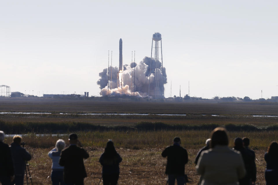 Spectators watch as Northrop Grumman's Antares rocket lifts off the launch pad at NASA Wallops Flight facility in Wallops Island, Va., Saturday, Nov. 2, 2019. The rocket is carrying a Cygnus spacecraft carrying supplies to the International Space Station. (AP Photo/Steve Helber)