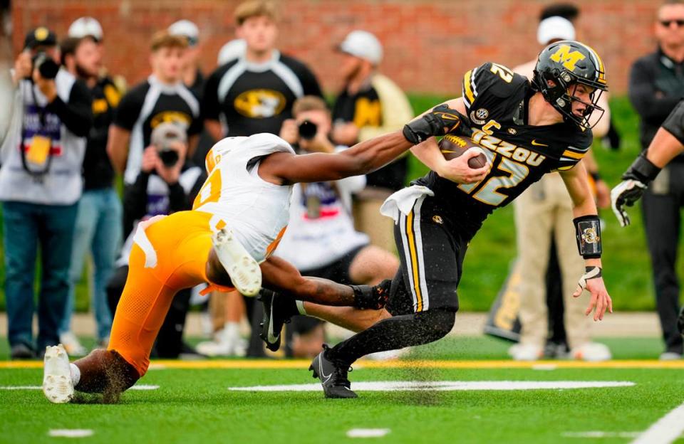 Missouri Tigers quarterback Brady Cook pulls Tennessee Volunteers defensive lineman Elijah Simmons for a couple of extra yards during Saturday’s game at Faurot Field. Jay Biggerstaff/USA TODAY Sports