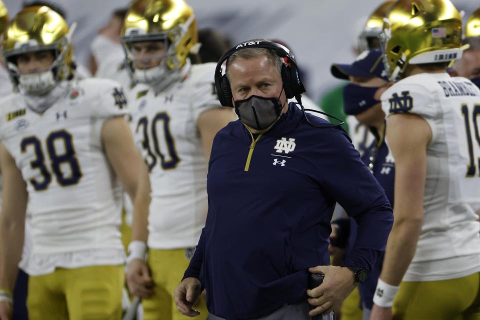 Notre Dame head coach Brian Kelly, center, watches play in the first half of the Rose Bowl NCAA college football game against Alabama in Arlington, Texas, Friday, Jan. 1, 2021. (AP Photo/Ron Jenkins)