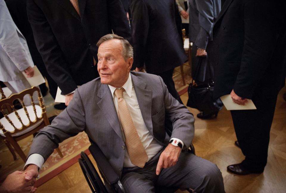 Former US President George H.W. Bush shakes hands as he departs from the East Room following the official portrait unveiling of his son former US President George W. Bush and wife Laura Bush May 31, 2012 at the White House in Washington, DC.   AFP PHOTO / Mandel NGAN        (Photo credit should read MANDEL NGAN/AFP/Getty Images)