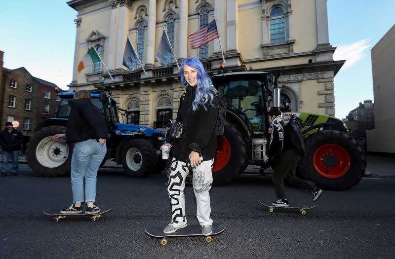 Skateboarders avoid the traffic jam caused by farmers' protest near Government Buildings in Dublin