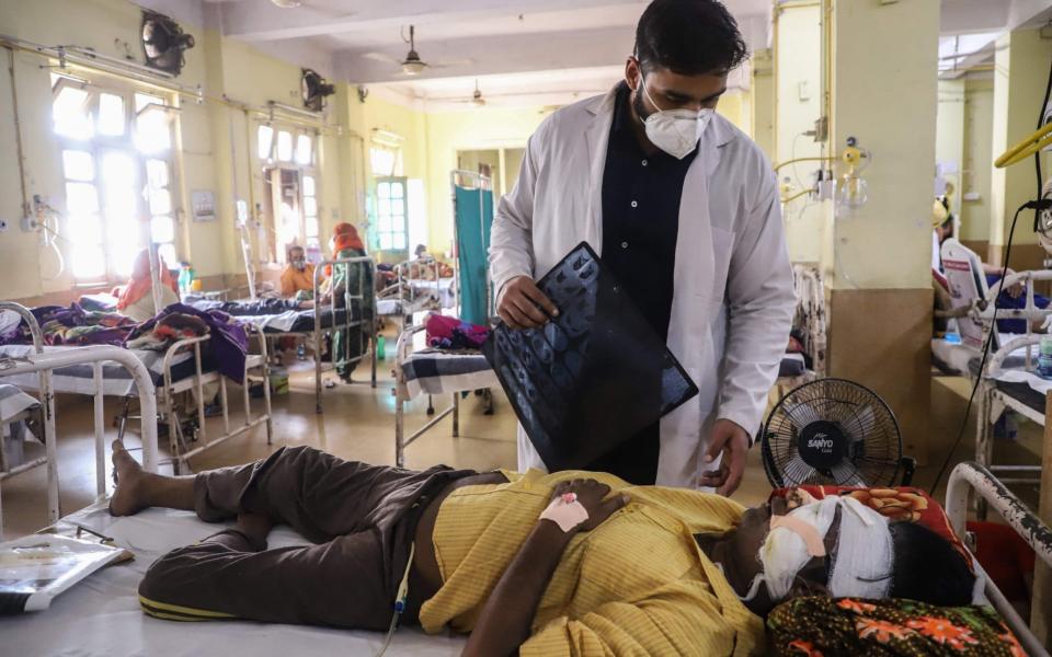 A doctor tends to a coronavirus patient suffering from Black Fungus - AFP