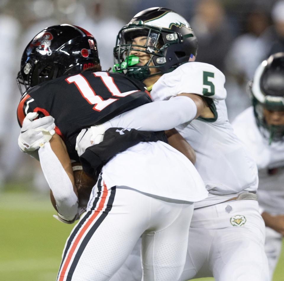 GlenOak's Cavaris Culler works to bring down McKinley's Keith Quincy, Friday, Oct. 13, 2023.