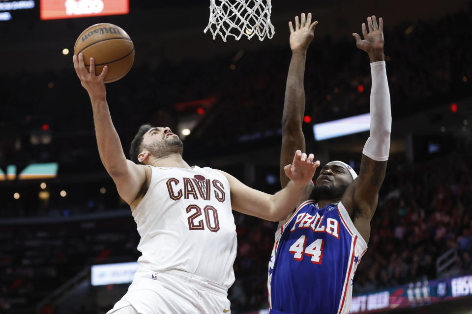 Cleveland Cavaliers forward Georges Niang (20) shoots against Philadelphia 76ers forward Paul Reed (44) during the second half of an NBA basketball game Friday, March 29, 2024, in Cleveland. (AP Photo/Ron Schwane)