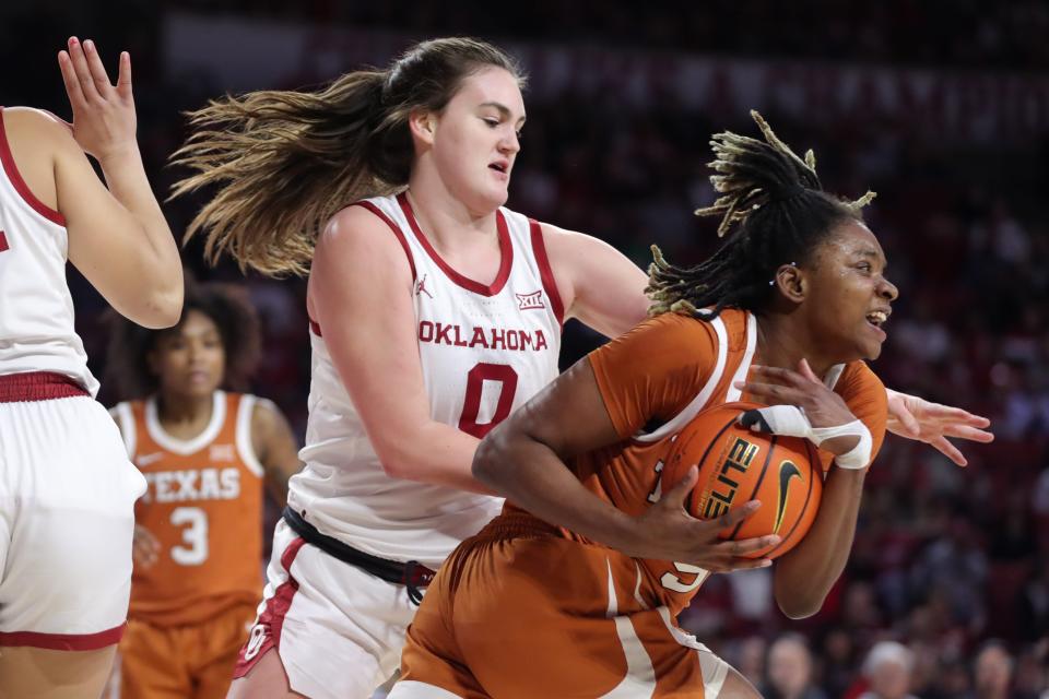 Texas forward DeYona Gaston secures the ball in front of Oklahoma center Beatrice Culliton during the Longhorns' 67-45 win over the Sooners on Saturday at the Lloyd Noble Center in Norman, Okla. The win broke the two teams' tie atop the Big 12 standings with only two games apiece to play.