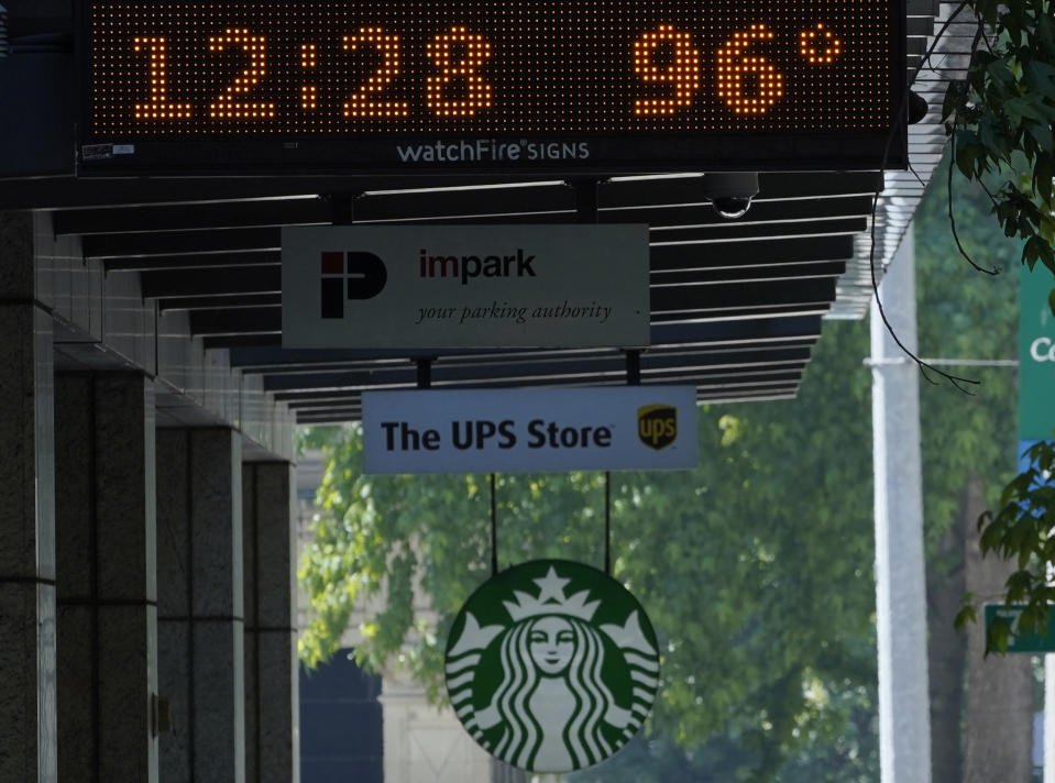 A parking garage sign shows the temperature at 96 degrees Fahrenheit in the shade, Monday, June 28, 2021, in downtown Seattle. Seattle and other cities broke all-time heat records over the weekend, with temperatures soaring well above 100 degrees Fahrenheit (37.8 Celsius). (AP Photo/Ted S. Warren)