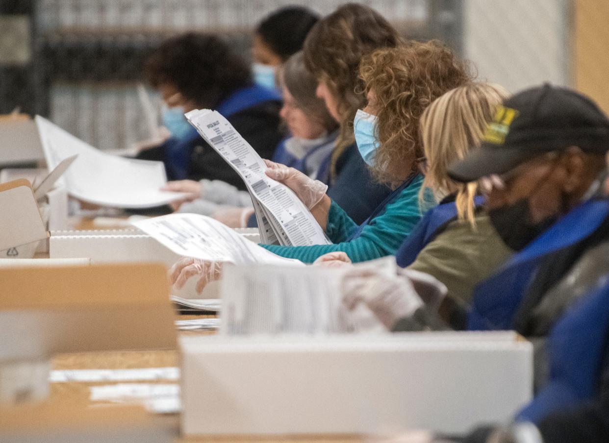 Election inspectors examine ballots at the San Joaquin County Registrar of Voters ballot counting facility at the Stockton Metropolitan Airport in south Stockton on Nov. 8.