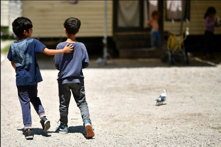 With summer holidays in full swing, youngsters scamper about the Roma camp outside the Italian capital