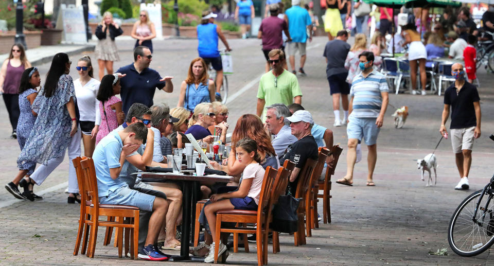 Visitors to Park Avenue in Florida dine al fresco on the street as restaurants and shops opened in the popular dining district, with Phase One restrictions in place