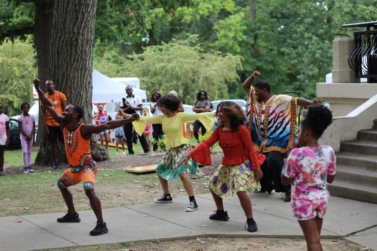 Attendees of AfriFest Cincy: Taste of Africa 2021 dance in Burnet Woods Park.