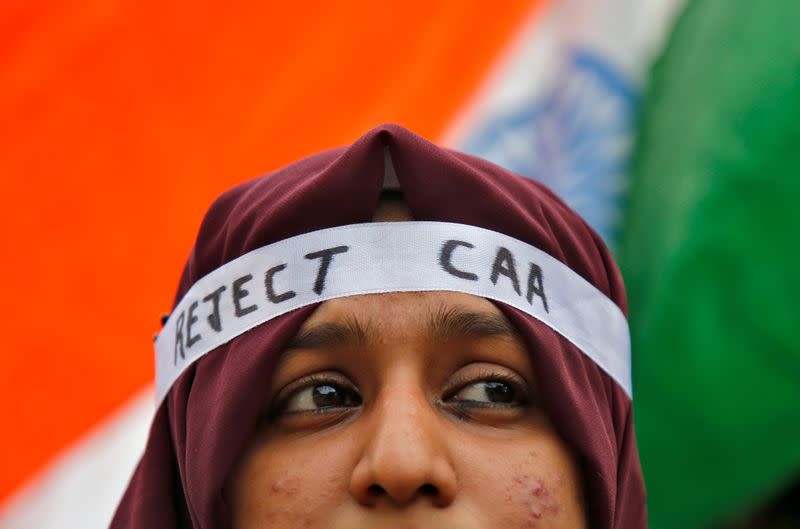 A student wearing a headband attends a protest march against a new citizenship law, in Kochi