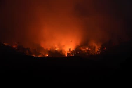 Seen in a long exposure photograph, the Soberanes Fire burns along ridges above Carmel-By-The-Sea, California, U.S. July 27, 2016. REUTERS/Noah Berger