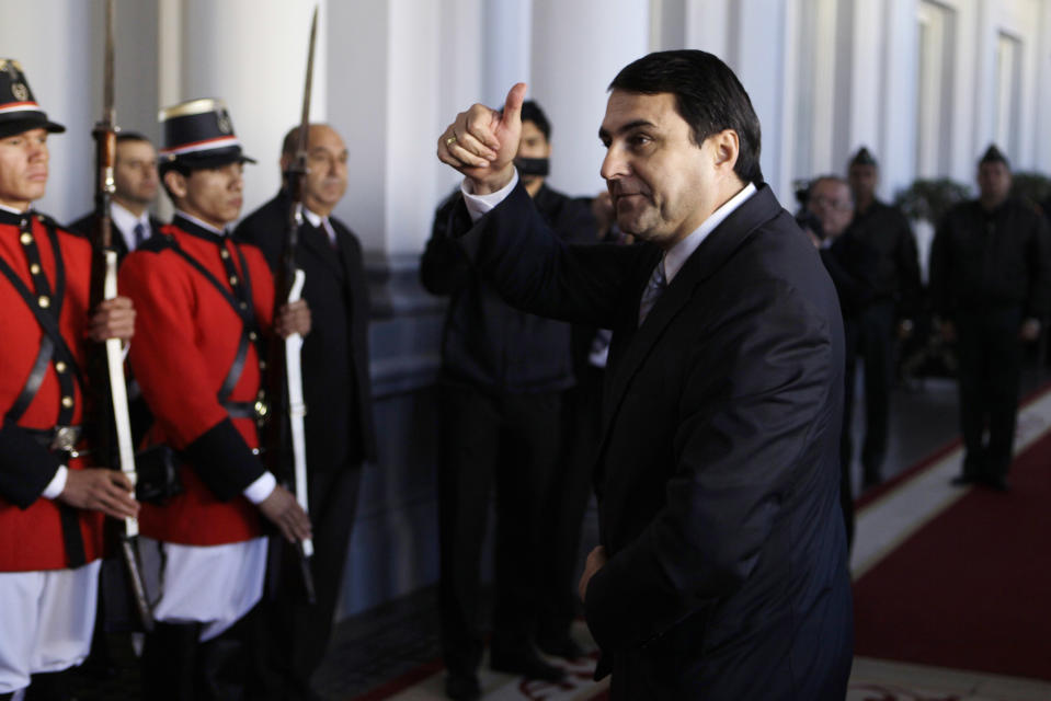 Paraguay's new President Federico Franco gives a thumbs up as he arrive to give a news conference at the presidential palace in Asuncion, Paraguay, Saturday, June 23, 2012. Paraguay's newly sworn in president is promising to honor foreign commitments and reach out to Latin American leaders after the Senate removed President Fernando Lugo from office in a rapid impeachment trial on Friday. (AP Photo/Jorge Saenz)