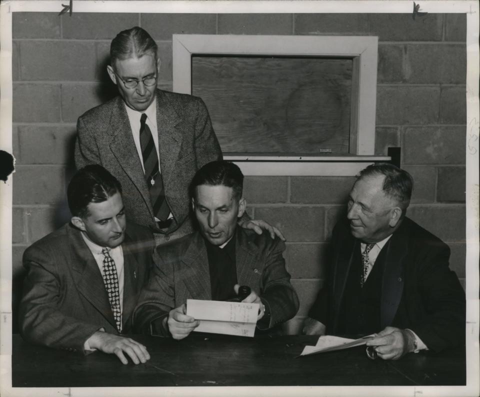 The 1950 "Communist Invasion" of Mosinee was planned as a lesson in Americanism by the Wisconsin Department of the American Legion. Seen here planning the "coup" are attorney John A. Decker of Milwaukee, member of the state Legion policy committee and who came up with the idea; C. M. Green, assistant general manager of the Mosinee Paper Mills Company; Publisher Francis Schweinler of the Mosinee Times; and Howard Dessert, a Mosinee lumber dealer.