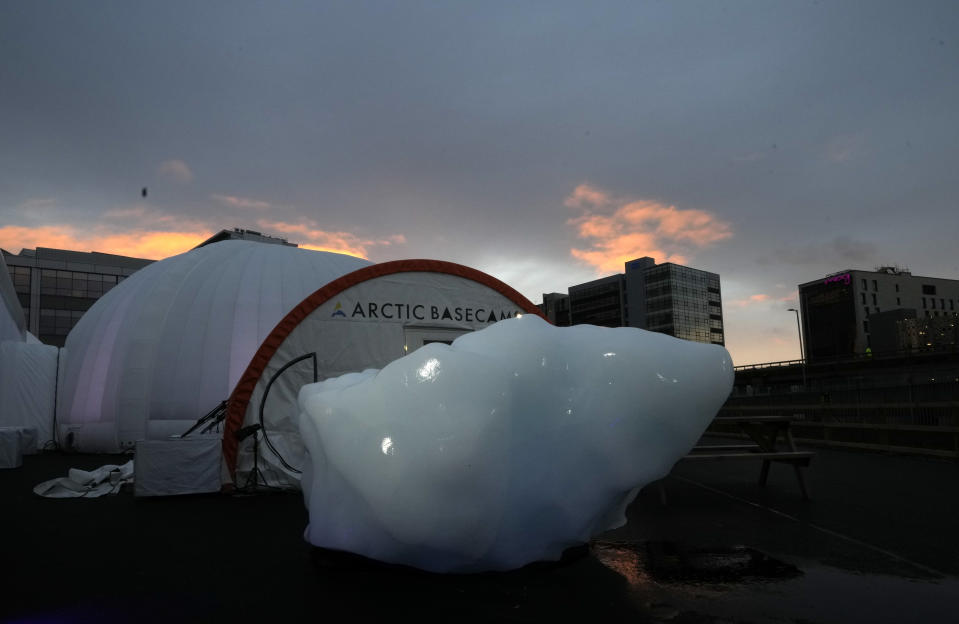 An iceberg delivered by members of Arctic Basecamp is placed on show near the COP26 U.N. Climate Summit in Glasgow, Scotland, Friday, Nov. 5, 2021. The four ton block of ice, originally part of a larger glacier, was brought from Greenland to Glasgow by climate scientists from Arctic Basecamp as a statement to world leaders of the scale of the climate crisis and a visible reminder of what Arctic warming means for the planet. (AP Photo/Alastair Grant)