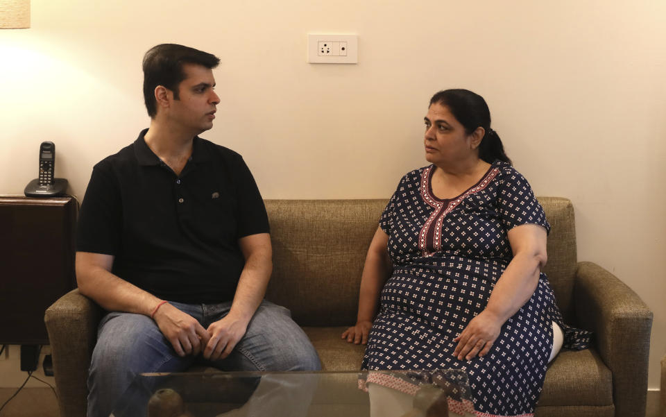 Karan Murgai, left, an IT management consultant for a multinational based in Dallas, talks to his mother Ushmi Murgai, at their home, in New Delhi, India, Tuesday, June 30, 2020. Murgai came to Delhi in March this year after his father died. Murgai and at least 1,000 others like him, whose U.S. visas are tied to their jobs in the U.S., are now stranded in India, after an executive order signed by President Donald Trump that suspends applications for H-1B and other high-skilled work visas from abroad. (AP Photo/Manish Swarup)