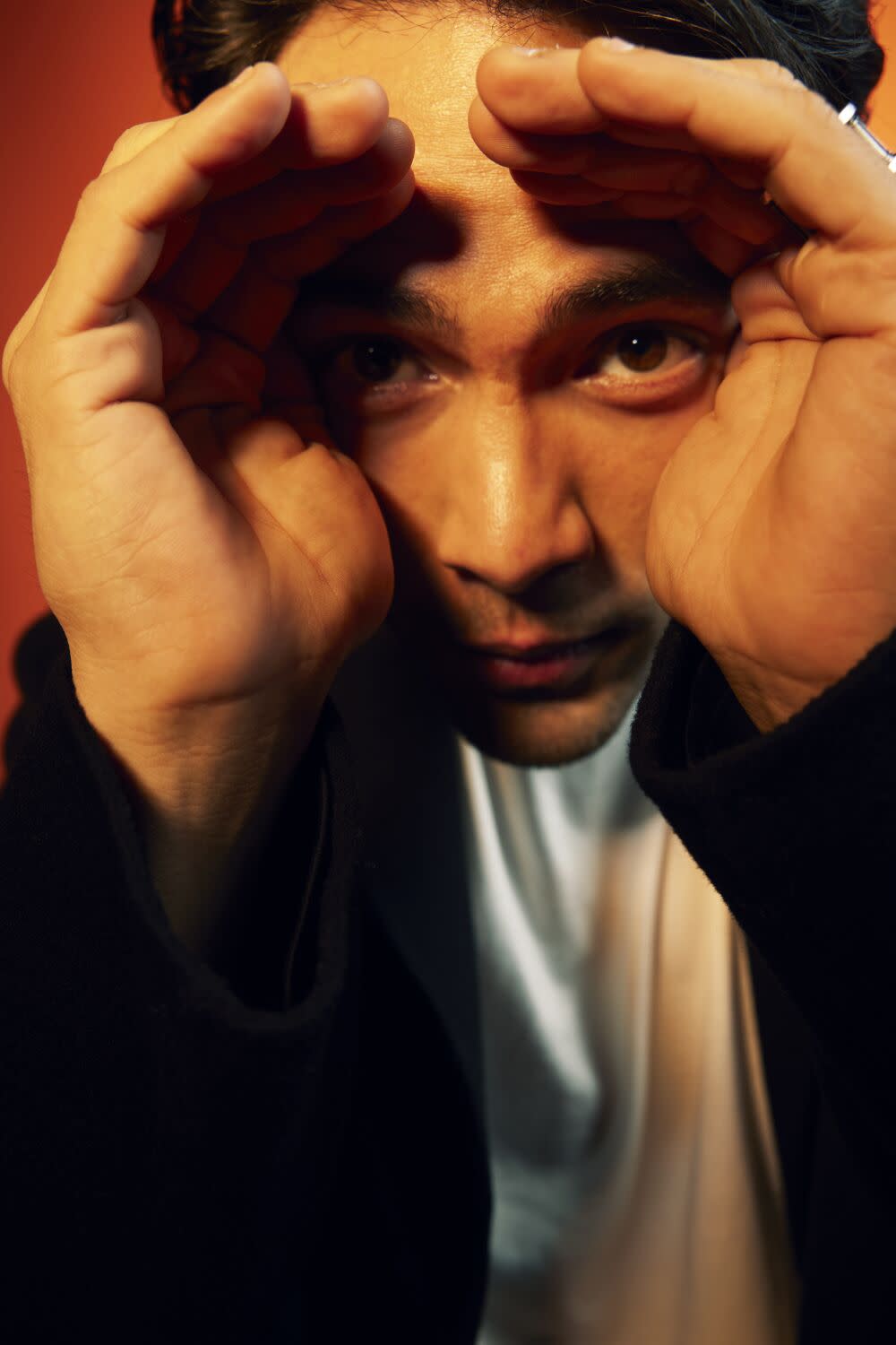 Actor Diego Calva cups his hands around his eyes