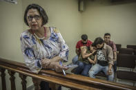 <p>Dina Meza, in court during a hearing where students from the Universidad Nacional Autónoma de Honduras, are on trial following their participation to a demonstration. Dina Meza is a well-known Honduran independent journalist and defender of the right to information and freedom of expression. She works to investigate and denoounce human rights violations in cases such as those of protesting students and other violations of the right to freedom of expression. Meza currently serves as the president of PEN Honduras, and manages the online news magazine Pasos de Animal Grande. Her work as a journalist and human rights defender has resulted in persecution and multiple threats directed towards both Meza herself and towards her family. (Photo: Francesca Volpi) </p>