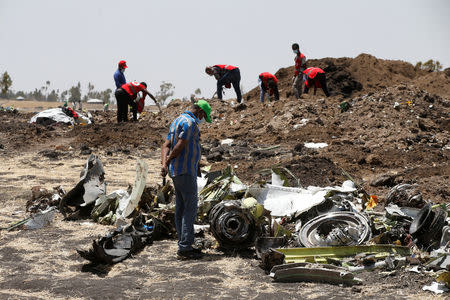 FILE PHOTO: A man watches debris at the scene of the Ethiopian Airlines Flight ET 302 plane crash, near the town of Bishoftu, southeast of Addis Ababa, Ethiopia March 12, 2019. REUTERS/Baz Ratner