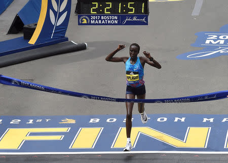 Edna Kiplagat, of Kenya, crosses the finish line to win the women's division of the 121st Boston Marathon in Boston, Massachusetts, U.S., April 17, 2017. REUTERS/Gretchen Ertl