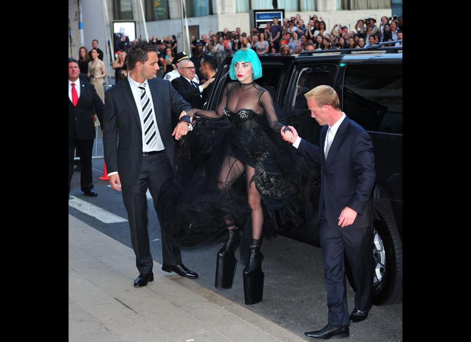 Shouldn't we all have two handsome handlers when our shoes don't function as footwear, but rather as works of art?    June 2011, New York City  (Photo Credit: Getty)