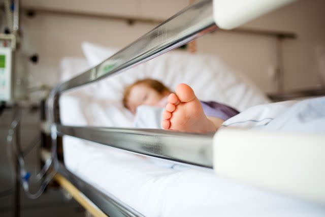 <p>Getty</p> A photo of a young girl lying in a hospital bed