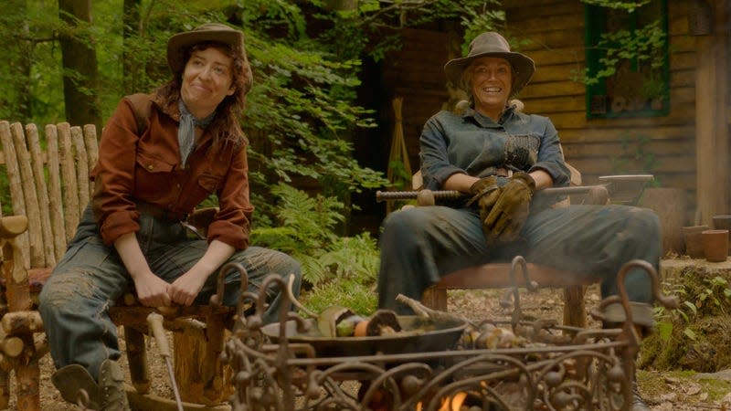 two woodswoman sitting at the fire