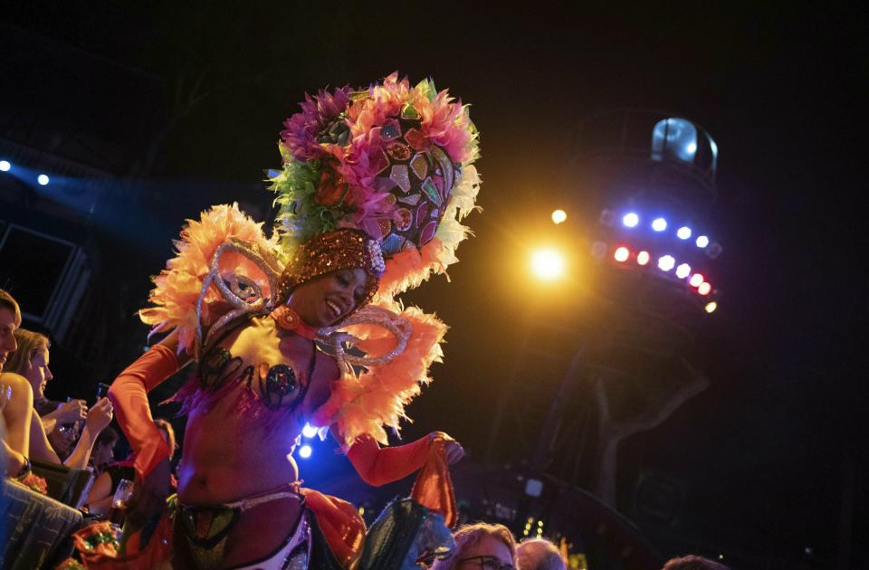 In this May 10, 2019 photo, a Tropicana cabaret dancer performs during the closing of an international tourism fair, in Havana, Cuba. Across the Florida Straits, the Trump administration is intently focused on cutting back on tourism as part of a campaign to smother the Cuban economy and force its government to sever ties with President Nicolás Maduro’s government in Venezuela. (AP Photo/Ramon Espinosa)