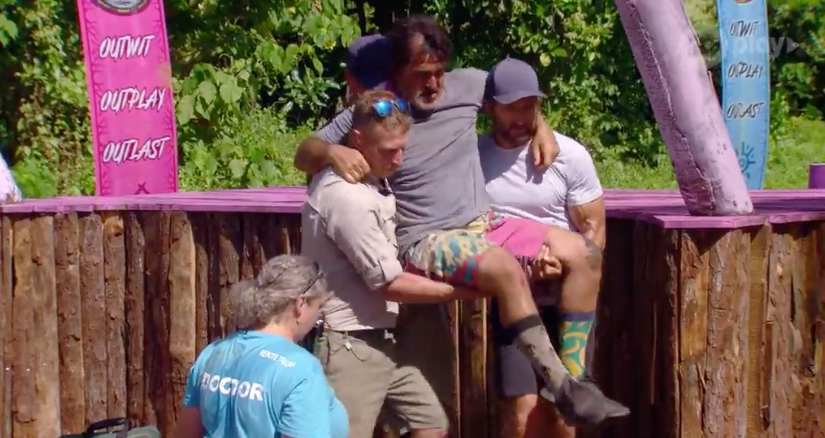 A photo of Australian Survivor contestant Ross Clarke-Jones being carried off set by host Jonathan LaPaglia after breaking his ankle.