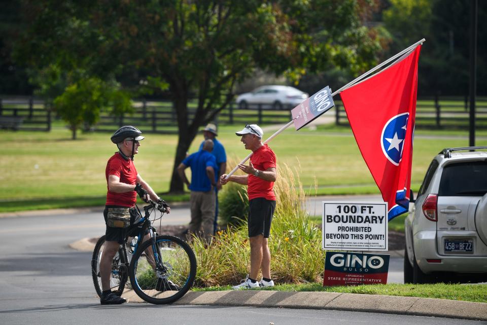 People stand outside of John P. Holt Brentwood Library on Election Day in Nashville, Tenn., Thursday, Aug. 4, 2022.