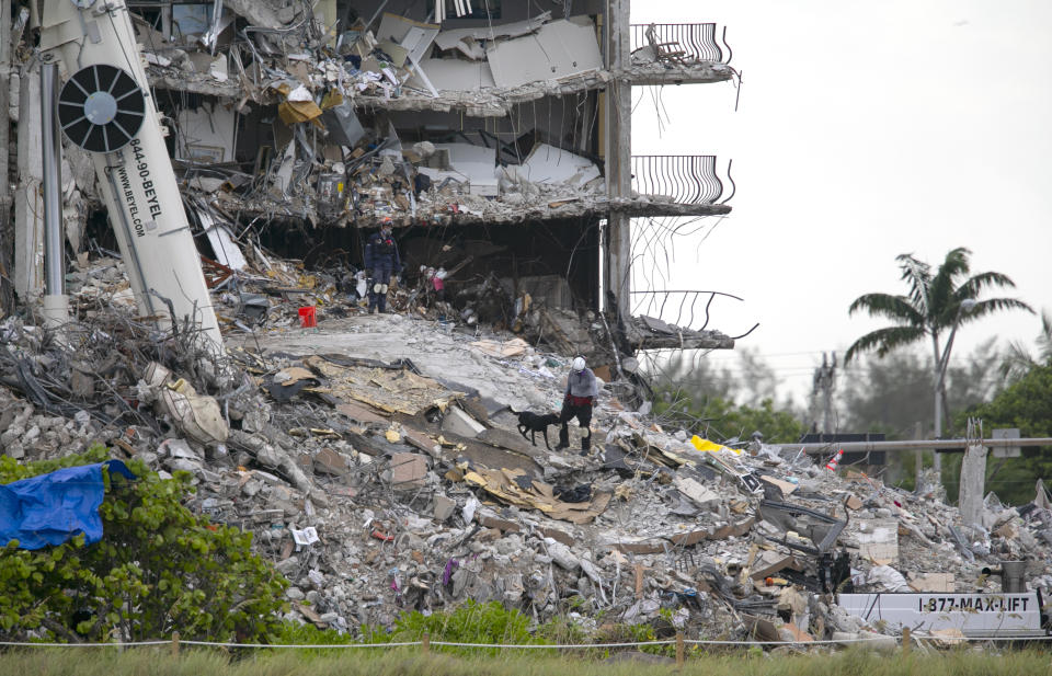 South Florida Urban Search and Rescue team look through rubble for survivors at the partially collapsed Champlain Towers South condo building in Surfside, Florida on Monday, June 28, 2021. As of early morning Monday, 152 people are missing and the death toll has climbed to nine.(Matias J. Ocner/Miami Herald via AP)