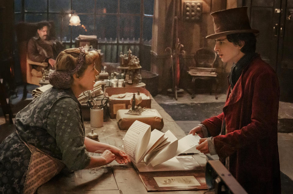 This image released by Warner Bros. Pictures shows Olivia Colman, left, and Timothee Chalamet in a scene from "Wonka." (Warner Bros. Pictures via AP)
