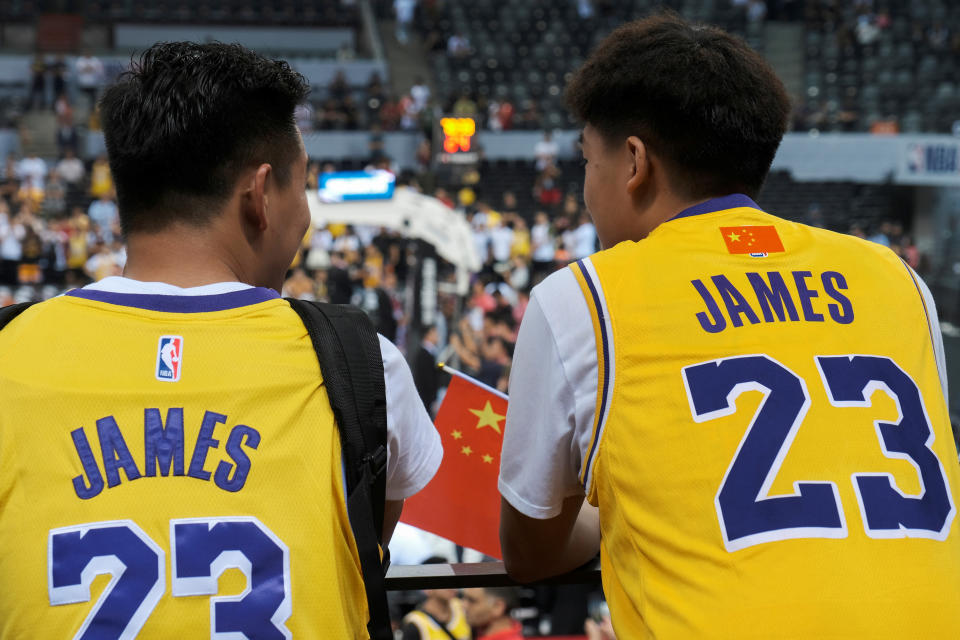 Basketball - NBA China Games - Los Angeles Lakers v Brooklyn Nets - Shenzhen, China - October 12, 2019. Fans are seen wearing LeBron James jerseys with an NBA logo covered by a Chinese national flag stickers during the game. REUTERS/Tyrone Siu